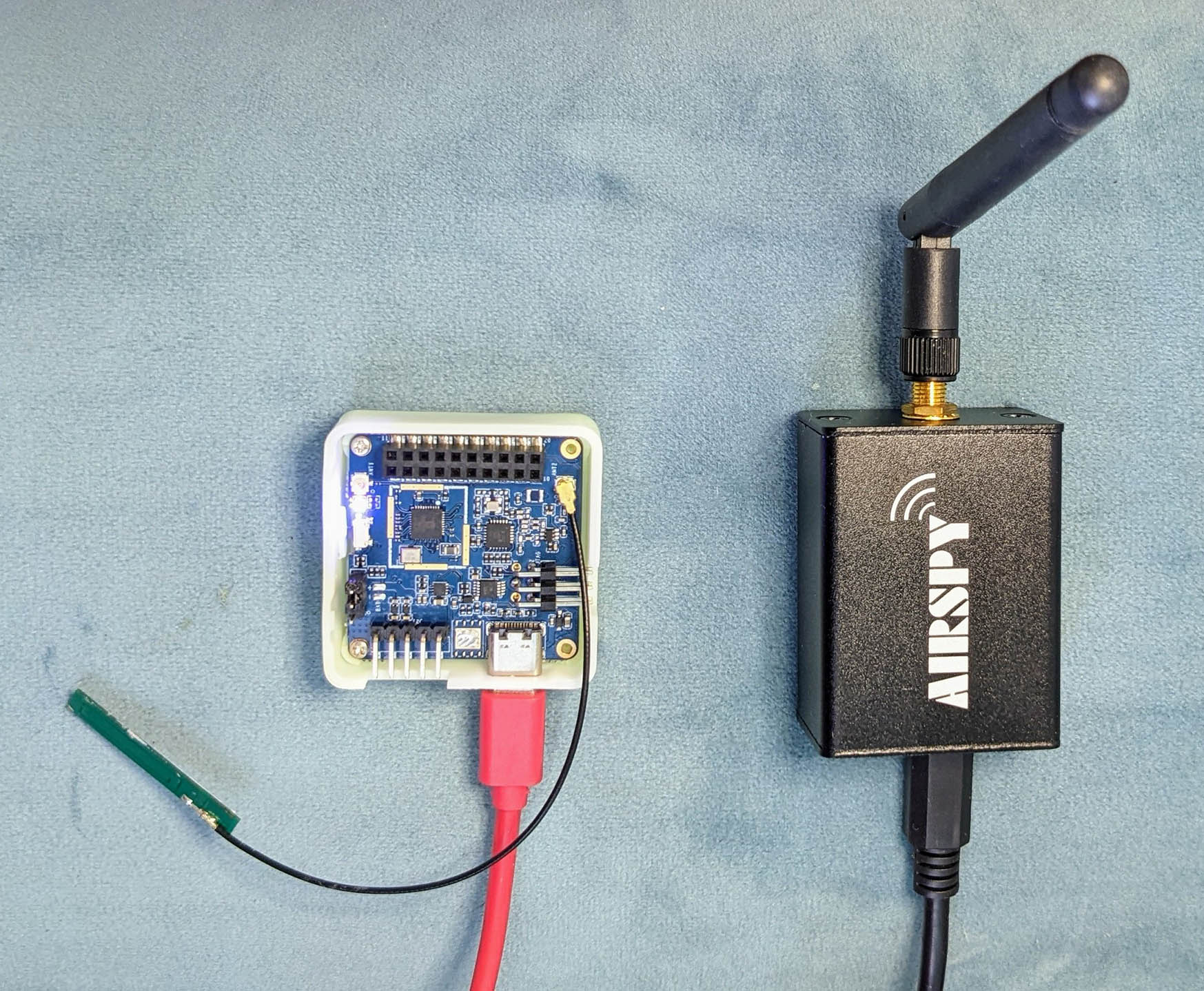 PineDio Stack BL604 RISC-V Board with onboard Semtech SX1262 LoRa Transceiver (left)... Sniffed wirelessly with Airspy R2 Software Defined Radio (right)