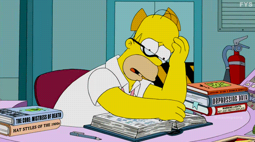 Homer Simpson, really worried and turning a lot of pages to read a manual