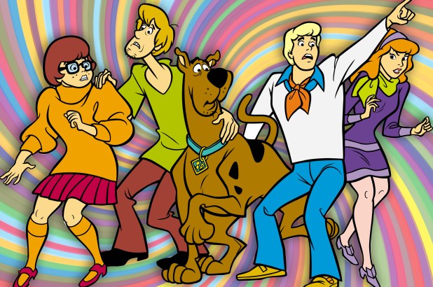 Cast of Scooby Doo, aligned from left to right as Velma, Shaggy, Scooby, Fred, and Daphne set over a psychedlic rainbow background