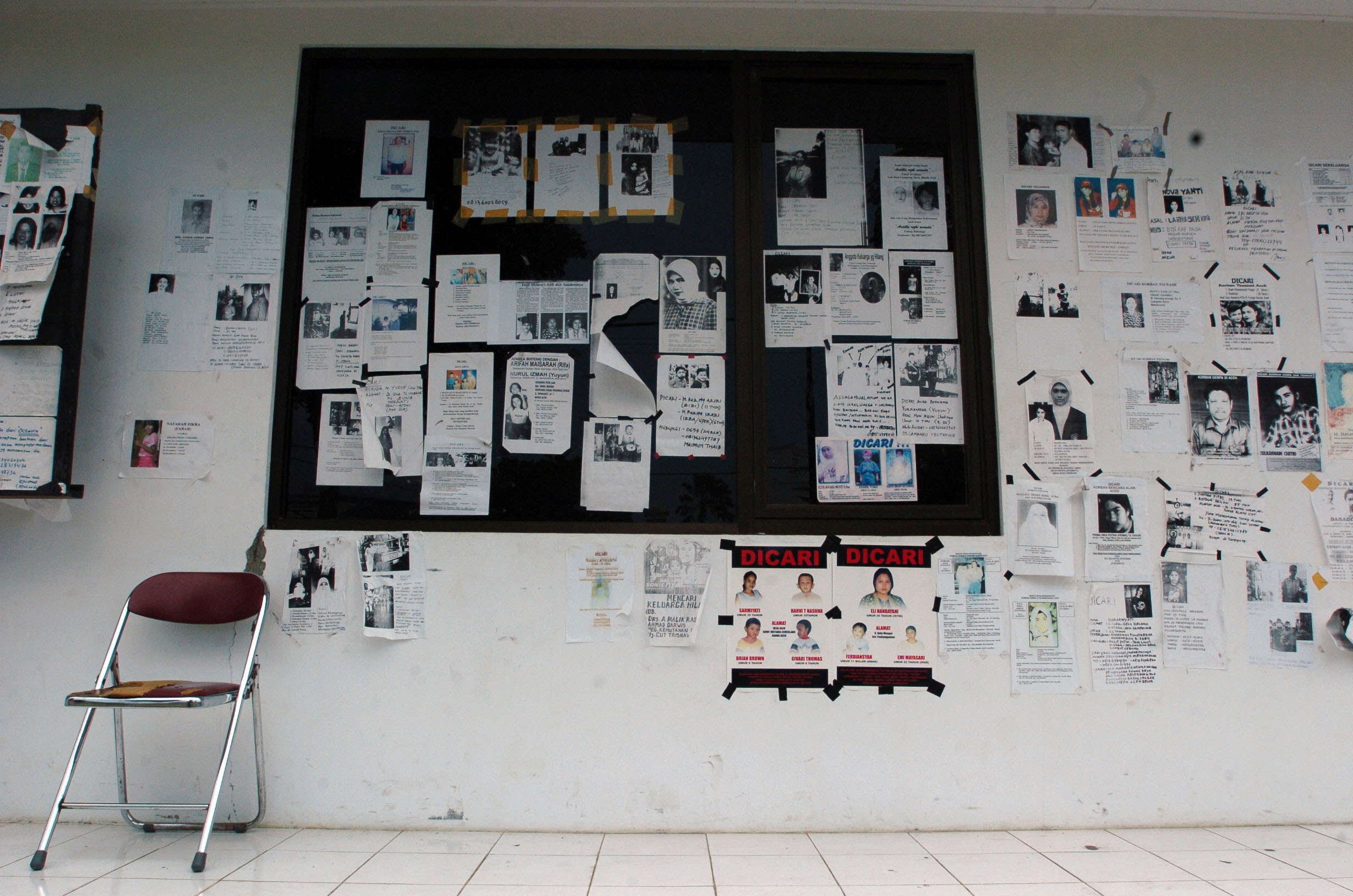 Flyers with information about missing persons line the walls outside Tentera Nasional Indonesia Military Hospital in Banda Aceh