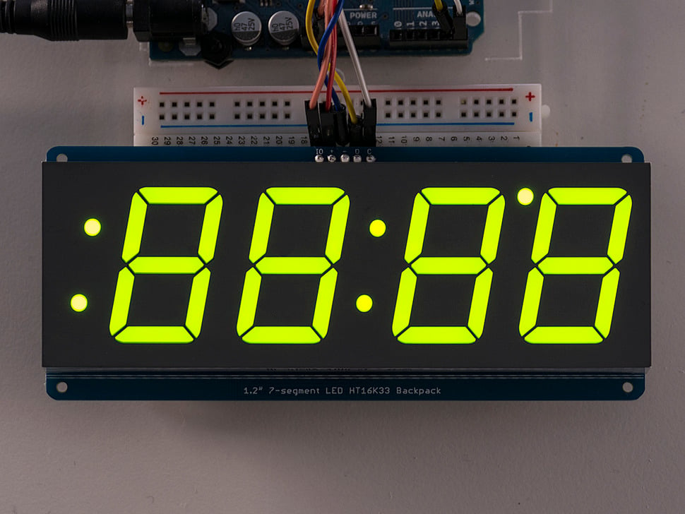 A picture of a breakout board with a 7-Segment Display