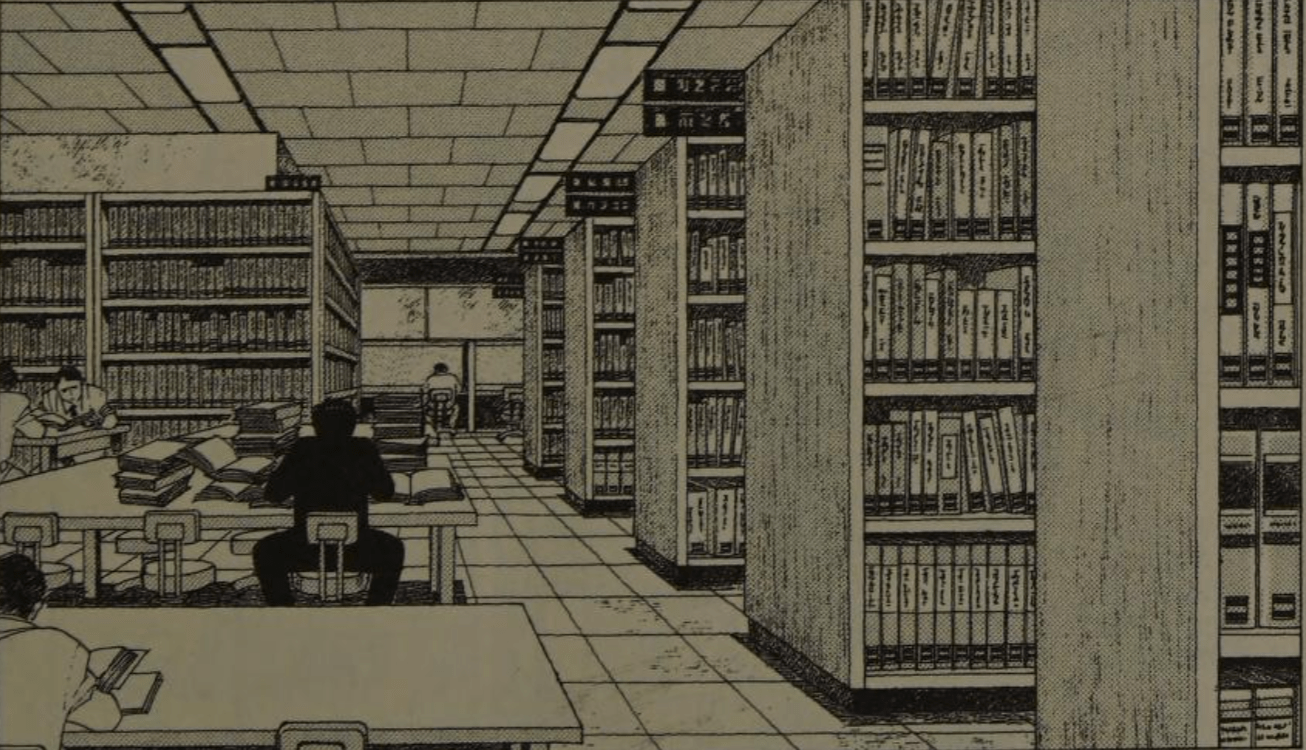 A picture of a man sitting at a table in a library