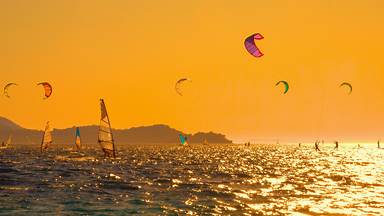 Kiteboarders and windsurfers off the Pelješac Peninsula, Croatia (© helivideo/Getty Images)