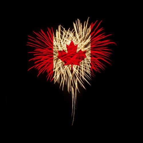 Canadian flag superimposed on heart-shaped fireworks explosion