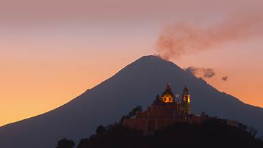 Church of Nuestra Señora de los Remedios and Popocatépetl, Puebla, Mexico (© Radius Images/Shutterstock)