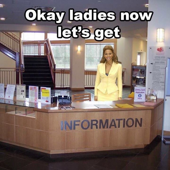 Beyonce is in a suit at an information desk with the slogan 'okay ladies now let's get information'