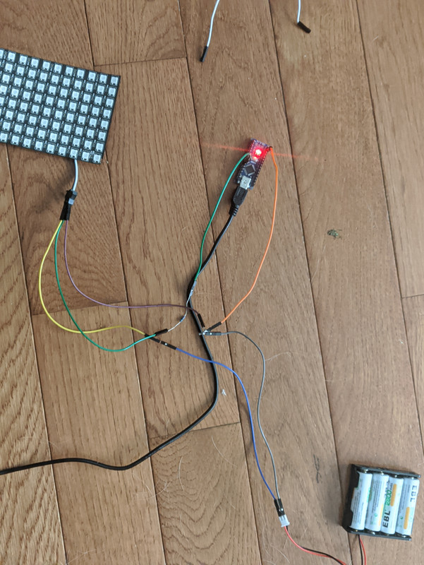 An Arduino Nano, LED matrix and battery power supply wired together