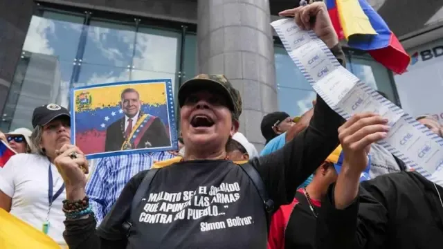 A demonstrator holds a picture of opposition candidate Edmundo Gonzalez during a demonstration to protest election results that awarded Venezuela's President Nicolas Maduro with a third term, in Caracas, Venezuela July 30, 2024