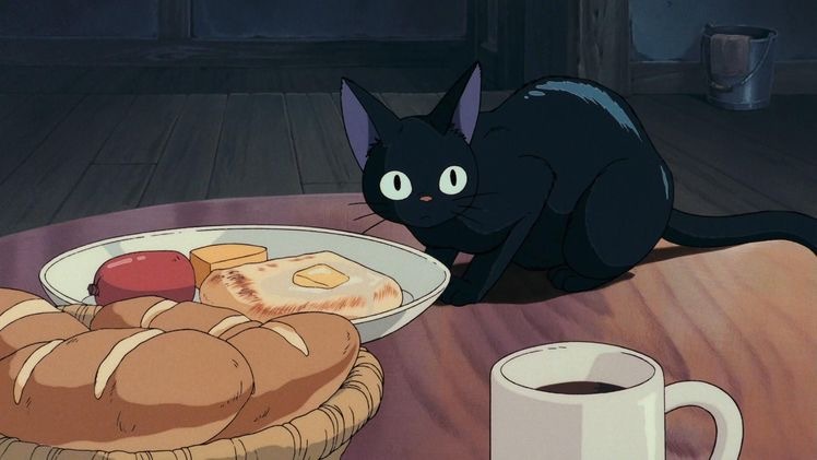 An image of a black cat curiously looking at the viewer on a table next to a plate of toast, bread, cheese, and susage in an anime artstyle