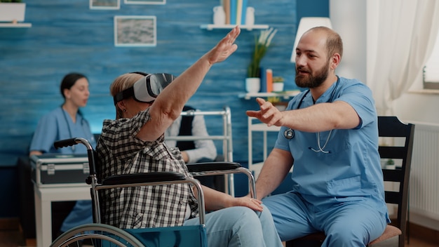 Retired woman using vr glasses and nurse assisting