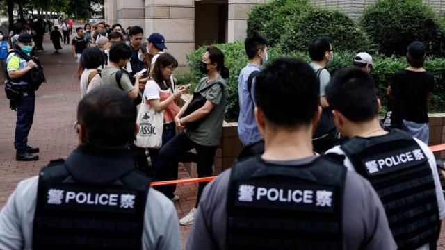 People queue up outside the West Kowloon Magistrates' Courts building, before the verdict of the 47 pro-democracy activists, charged under the national security law, in Hong Kong, China, May 30, 2024. REUTERS/Tyrone Siu