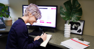 Dental office manager planning out a year-end patient recall system