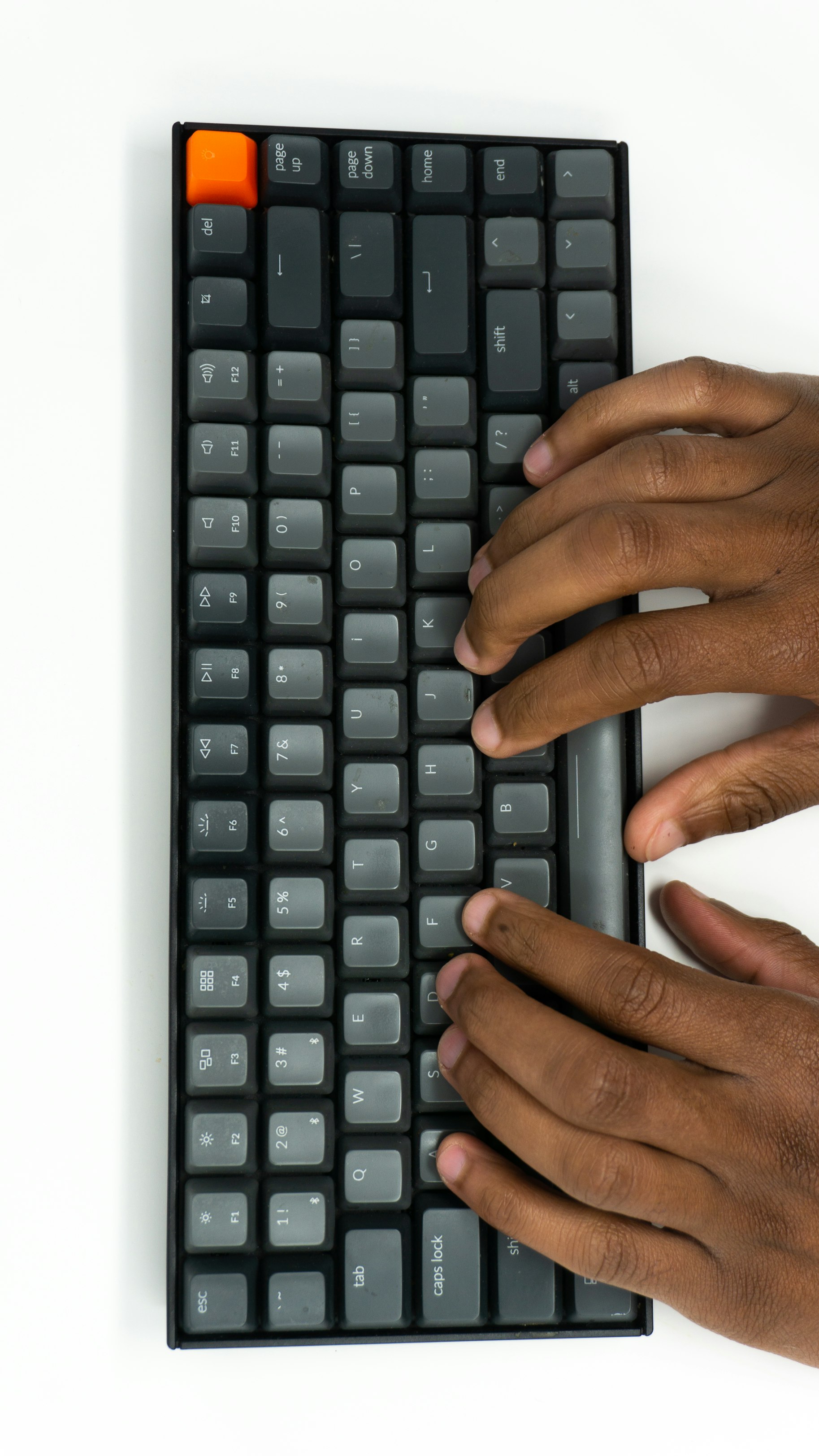 fingers typing on keyboard