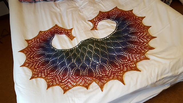 A shawl in deep rainbow colors.