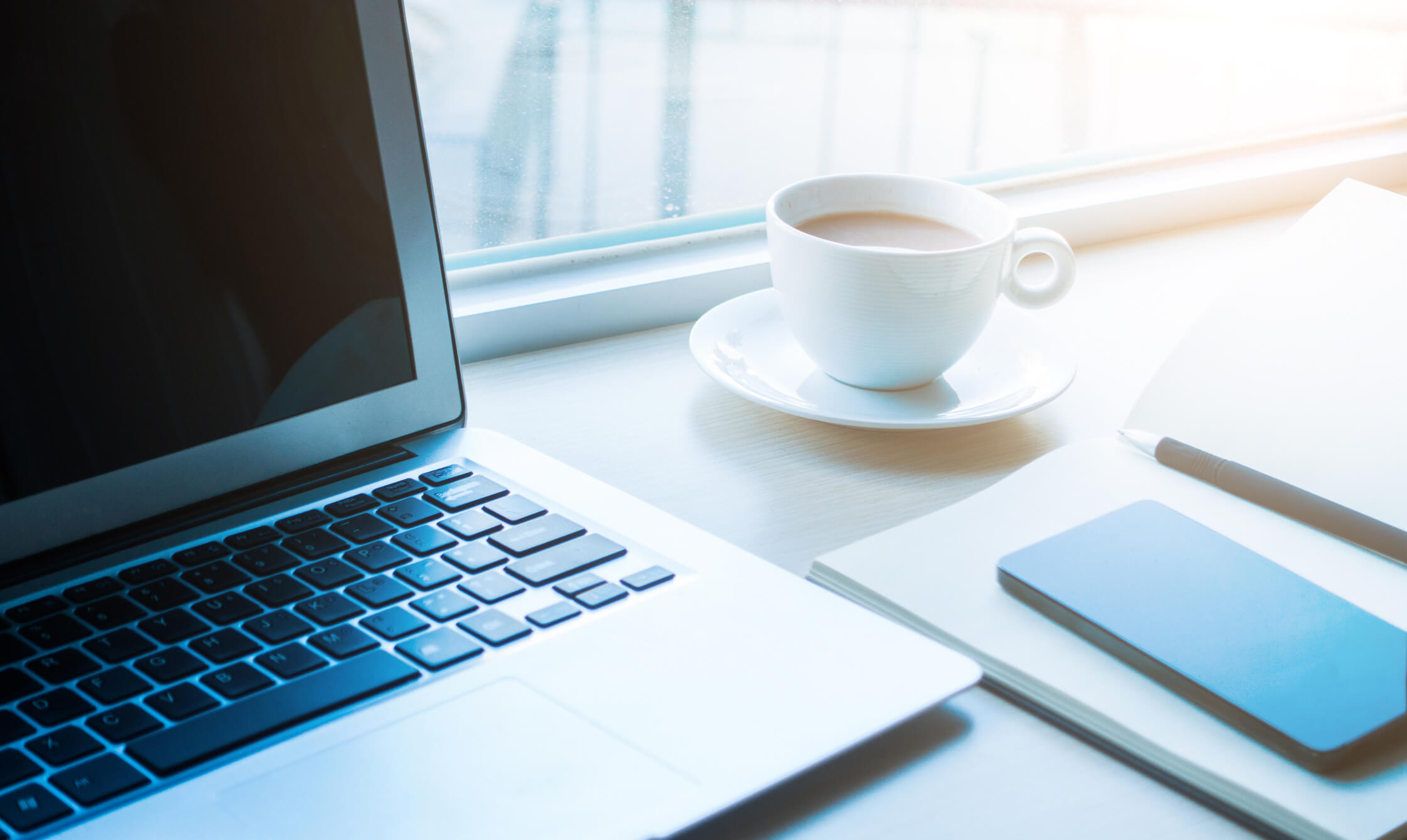 Laptop and a cup of coffee,mobile phone on office desk