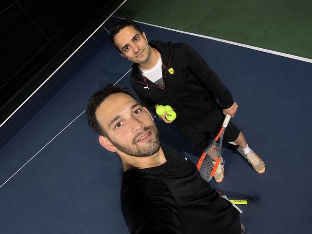Tennis with a friend on an indoor court