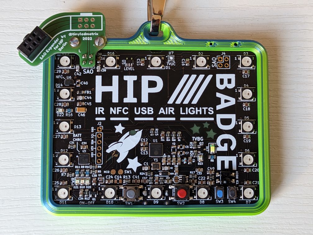 Image of the HiP badge with custom frame and SAO (I2C) expander