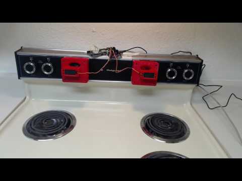 Two servo controlled oven knob placements over a Hotpoint oven