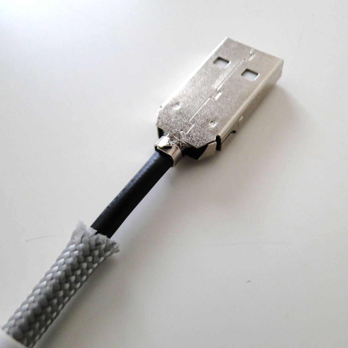 Fold the metal arms around the cable with the long nose pliers