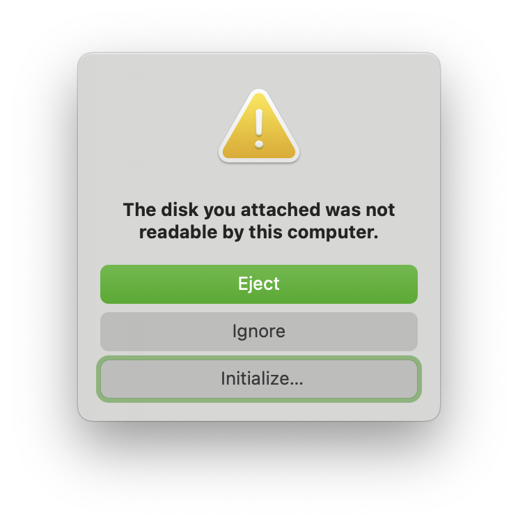 macOS warning dialog saying 'The disk you attached was not readable by this computer.' with three buttons: eject, ignore, initialize.