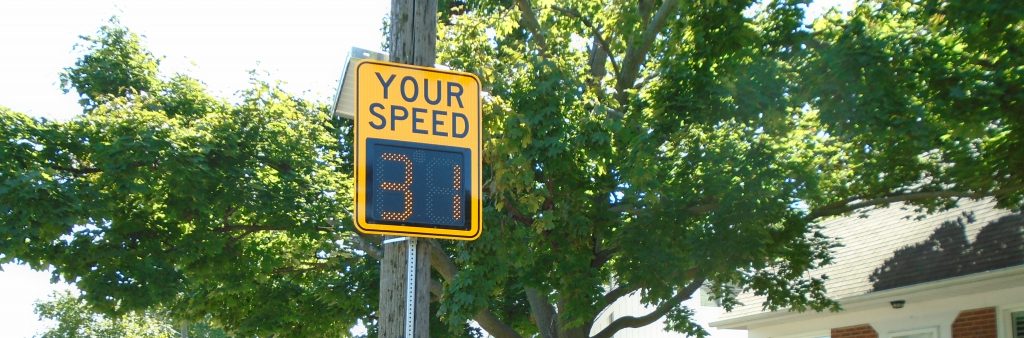 'A sign mounted on a pole with the words "Your Speed" and underneath a digital sign displaying "31"'