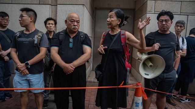 Members of the League of Social Democrats (LSD) protest outside the West Kowloon Magistrates' Courts during a verdict for 47 pro-democracy activists in Hong Kong, China, 30 May 2024. A court in Hong Kong on 30 May convicted 14 defendants over 'conspiracy to subvert the state power' under the national security law, while two were acquitted, in trial of 47 prominent pro-democracy divs in Hong Kong arrested and charged in 2021.