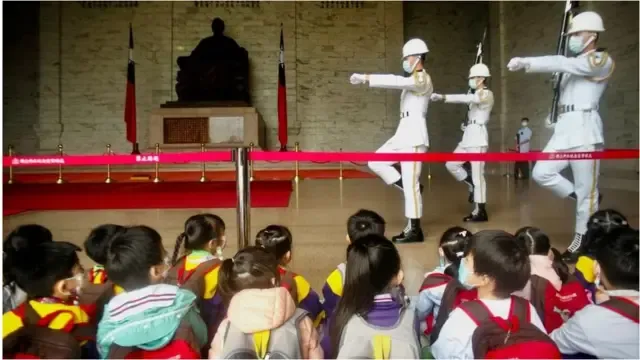 Kindergarten children watch honour guards at Chiang Kai-shek Memorial Hall in Taipei on October 11, 2022