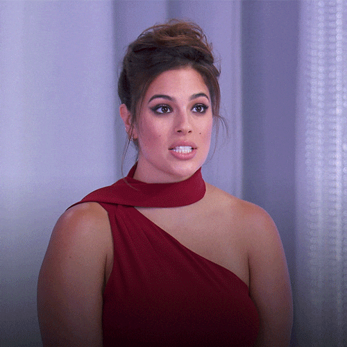 Lady in red dress emphatically gesturing and saying 'flawless'
