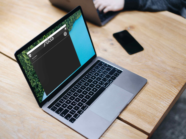 macbook pro space gray on the wooden table with wled