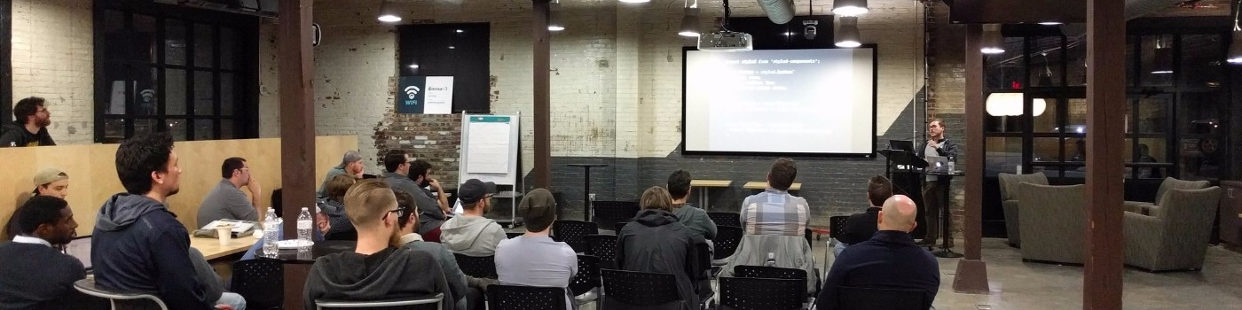 Image banner from my LinkedIn profile. Photo of me giving a talk at a local tech meetup.