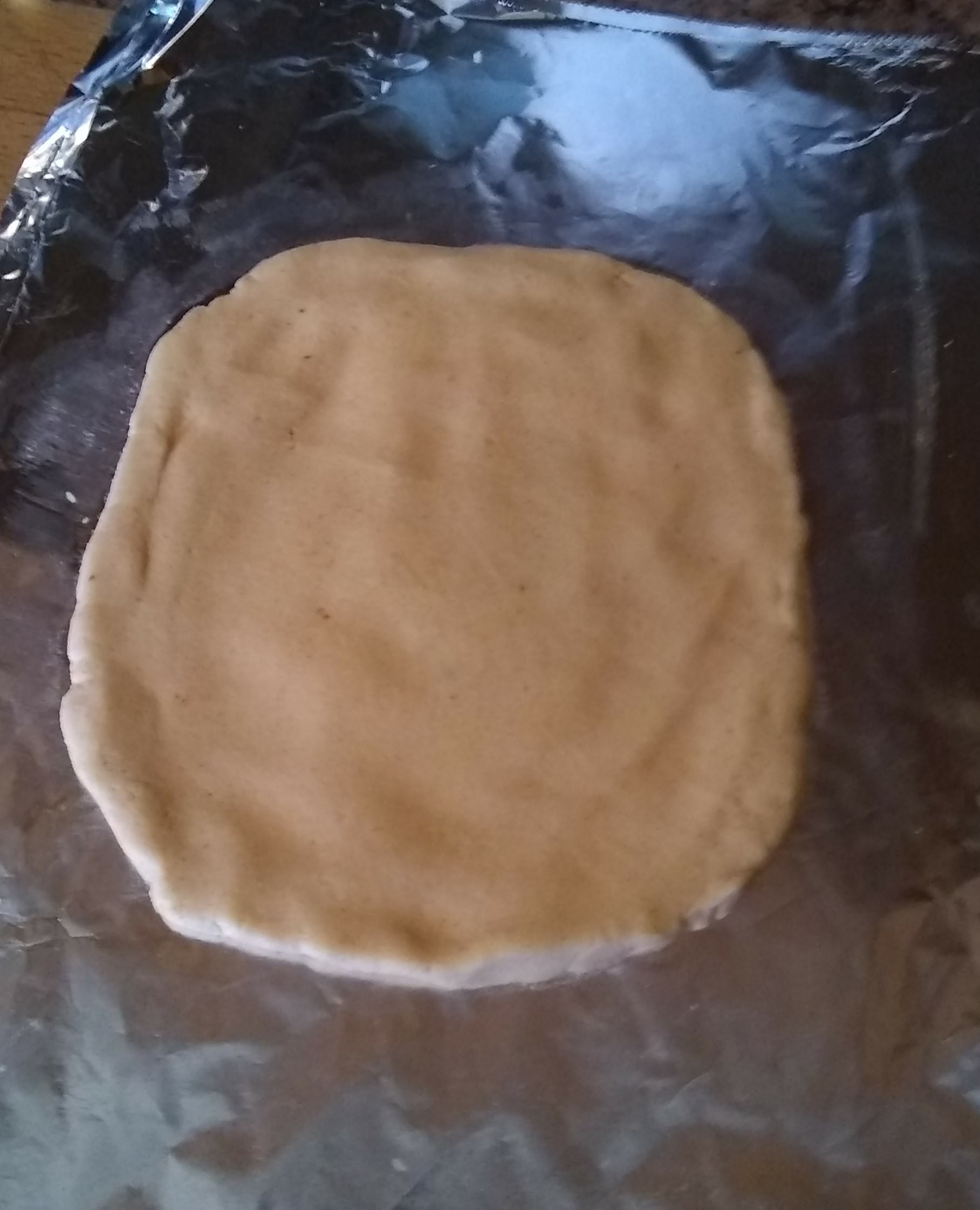 Image of dough spread out on tin foil