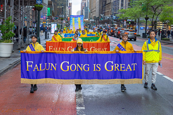 Falun Gong practitioners take part in a parade to celebrate Worl