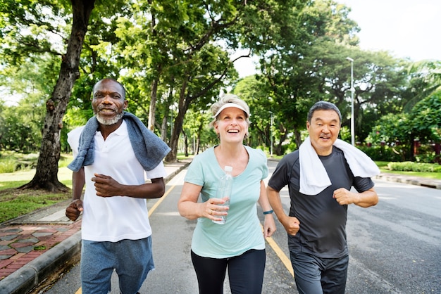 Group of senior friends jogging together in a park Free Photo