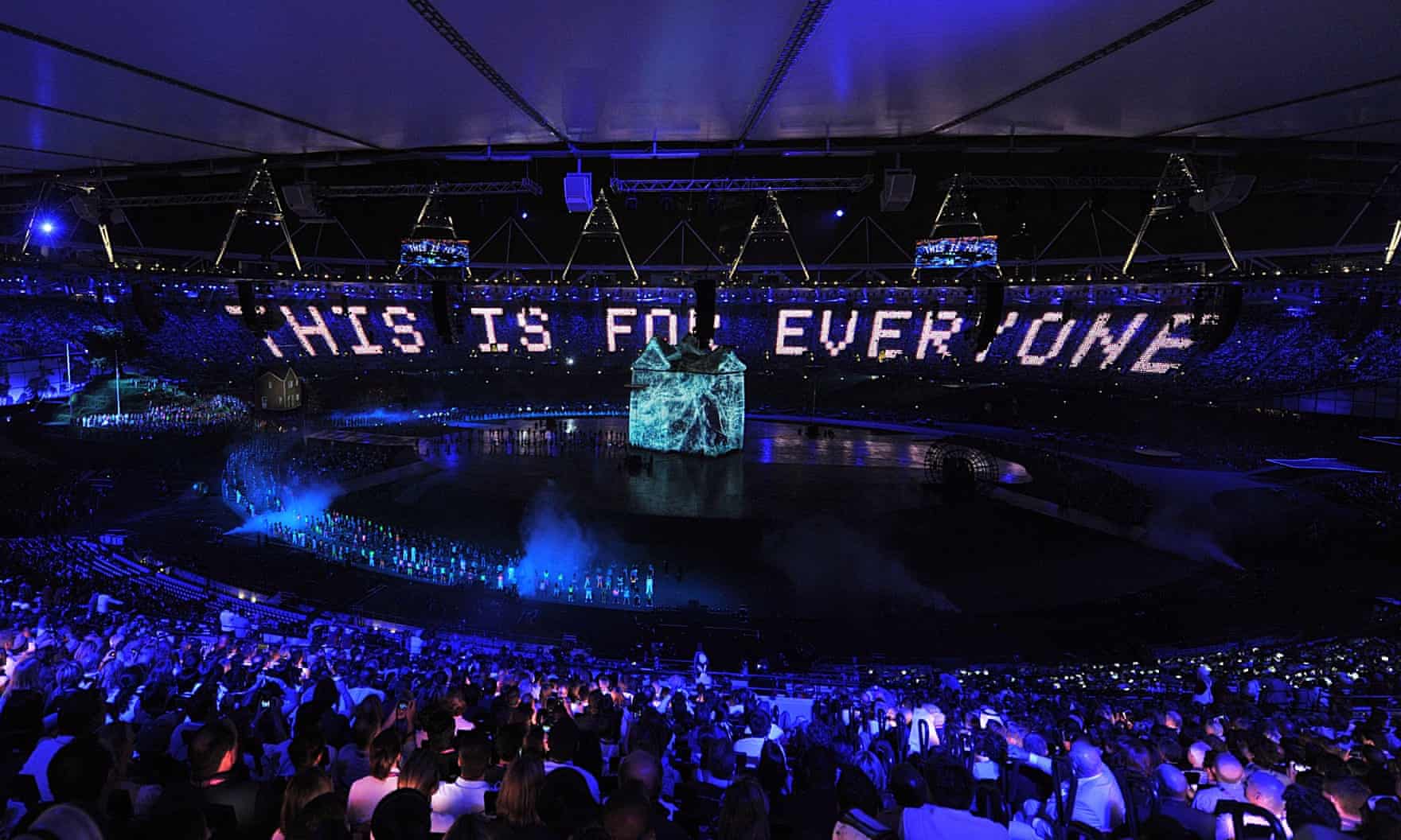 the opening olypmic games ceremony stadium. The crowd appears to be lit blue and there is white text which reads 'this is for everyone' 