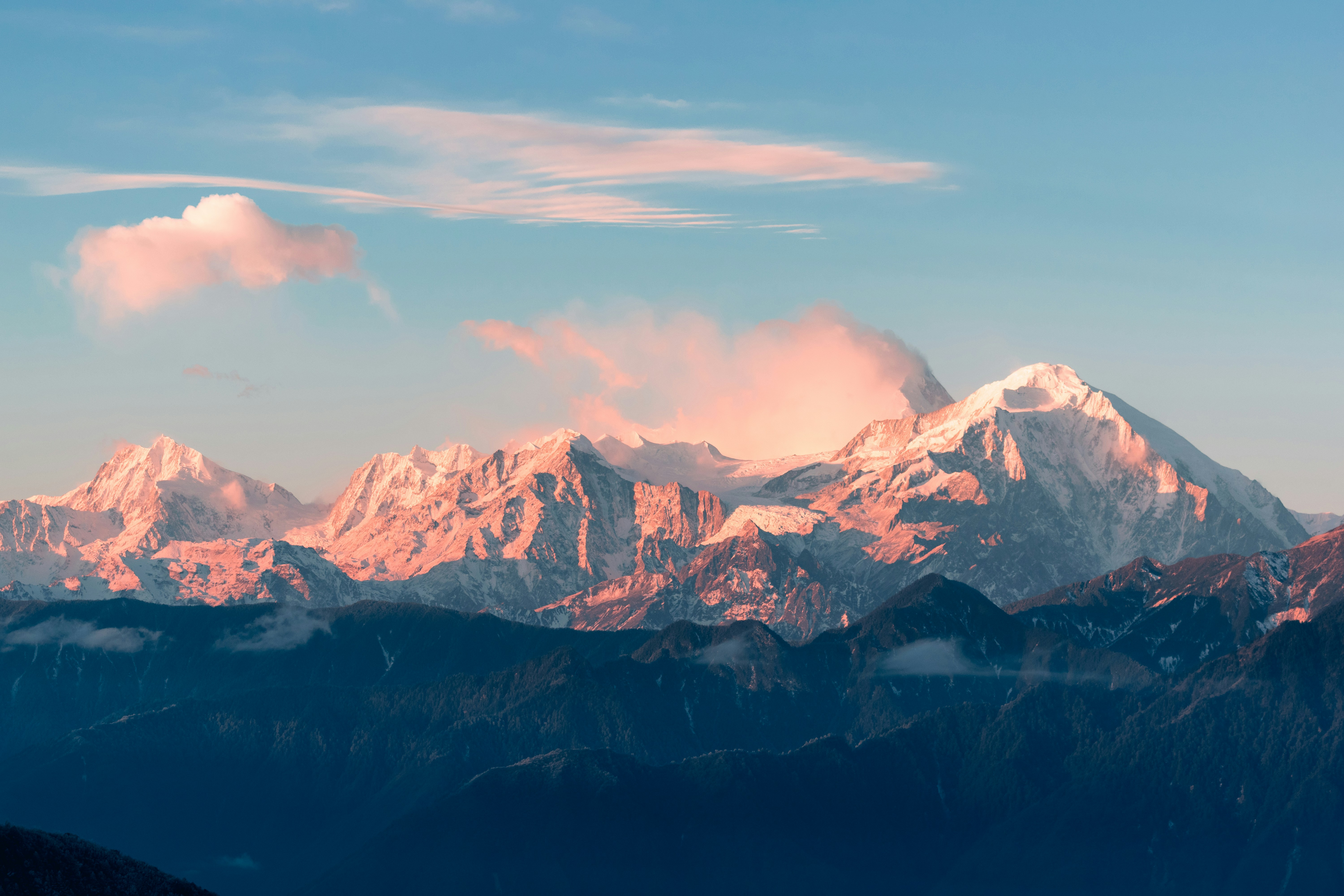 Image of a man standing on a cliff overlooking a mountain range