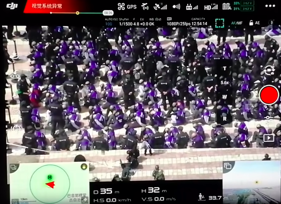 Video still of 2019 10 drone footage of blindfolded Xinjiang prisoners being marched taken at time 00%3A30
