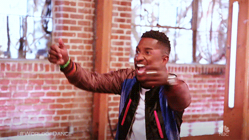A guy chest shaking/dancing happily with his arms out