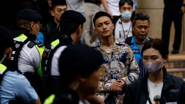 Lee Yue-shun is escorted by police outside the West Kowloon Magistrates' Courts building after being acquitted of charges under the national security law, in Hong Kong, China, May 30, 2024. REUTERS/Tyrone Siu