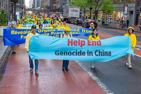 Falun Gong practitioners take part in a parade to celebrate Worl